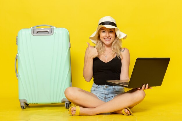 Front view young female holding her laptop and smiling