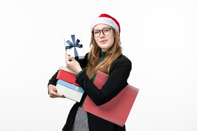 Front view young female holding holiday presents on white wall gift books new year