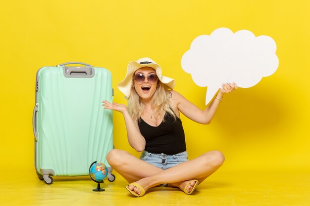 Free photo front view young female holding huge white speech bubble