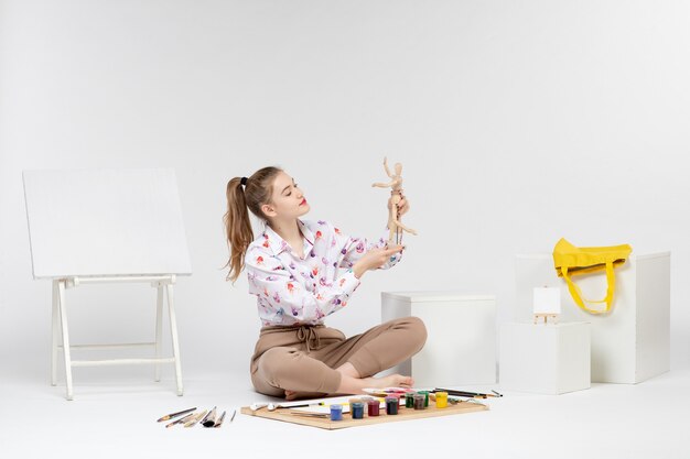 Front view young female holding human figure on white background