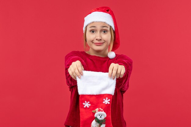 Front view young female holding red christmas sock, christmas holiday red