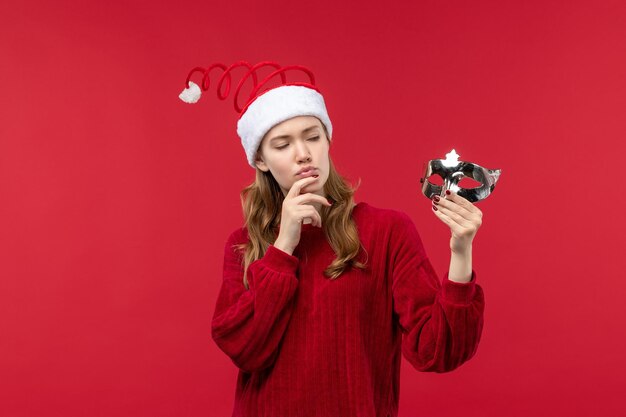 Front view young female holding silver mask, holiday christmas