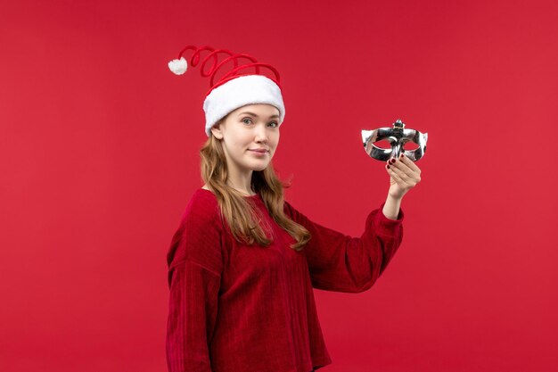 Front view young female holding silver mask, holidays emotion christmas