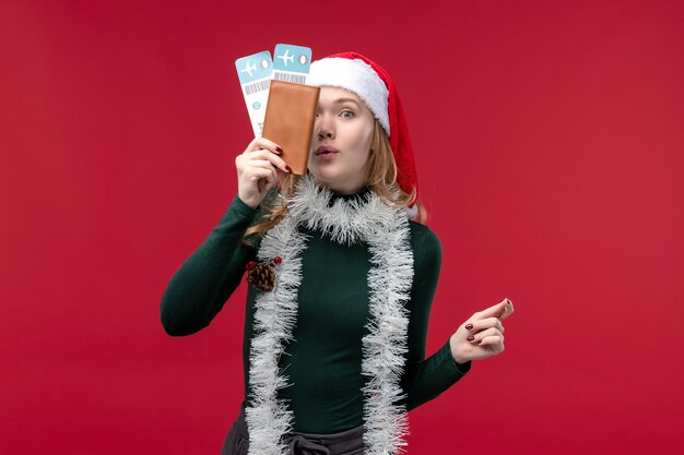 Front view young female holding tickets on red background