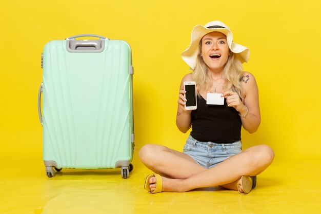 Front view young female holding white card and phone