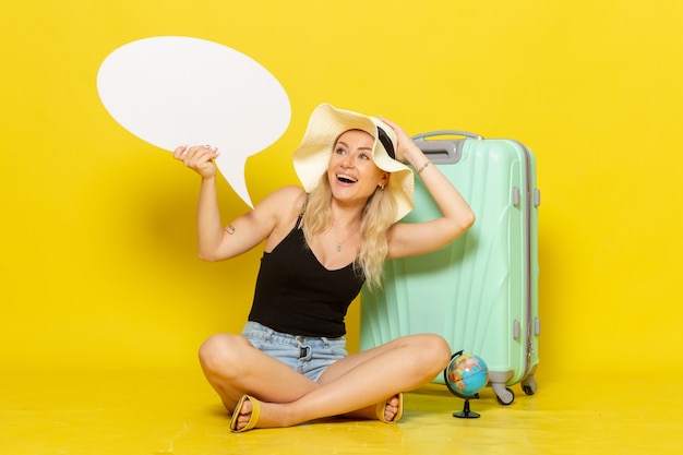 Free photo front view young female holding white speech bubble