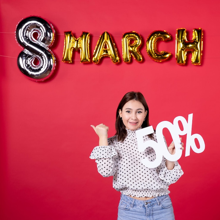 Free Photo front view young female holding writing on march decorated red background shopping beauty holiday affectionate equality fashion mall