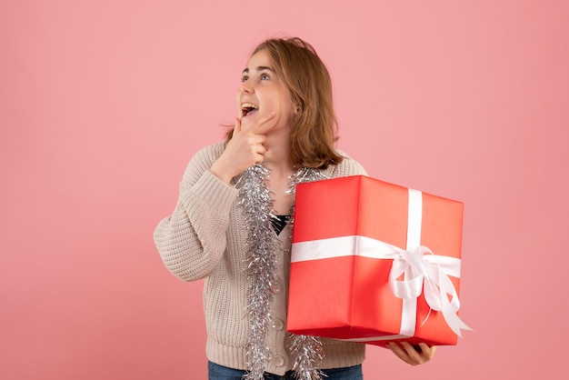 Free photo front view young female holding xmas present