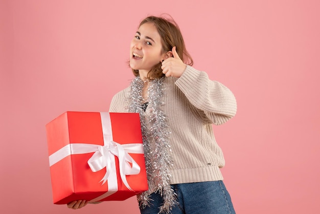 Front view young female holding xmas present