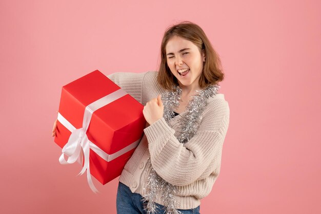 Front view young female holding xmas present