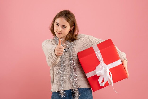 Front view young female holding xmas present