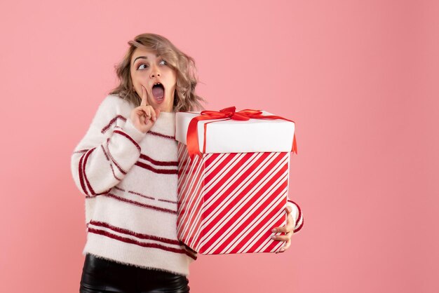 Front view young female holding xmas present