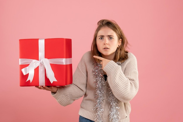 Front view young female holding xmas present