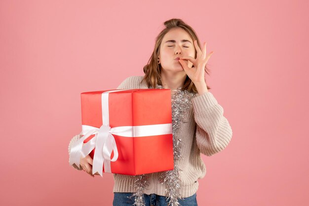 Free photo front view young female holding xmas present