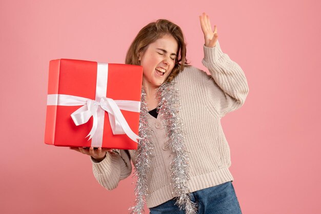 Front view young female holding xmas present