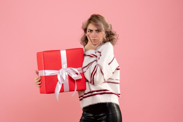 Front view young female holding xmas present