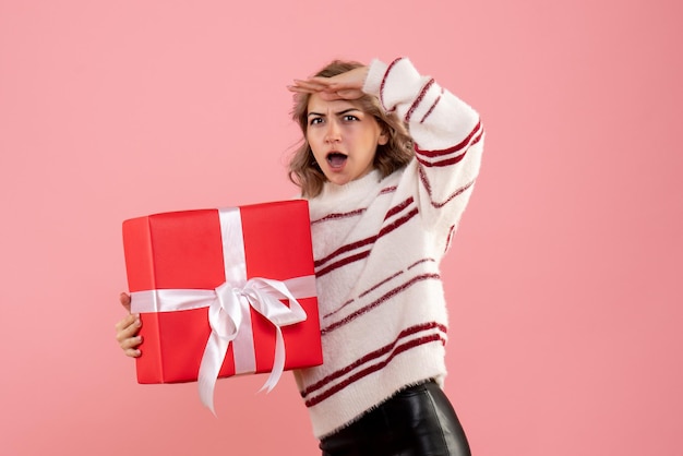 Front view young female holding xmas present