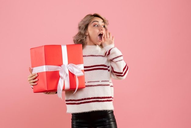 Front view young female holding xmas present