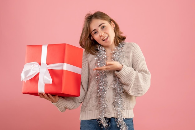 Front view young female holding xmas present