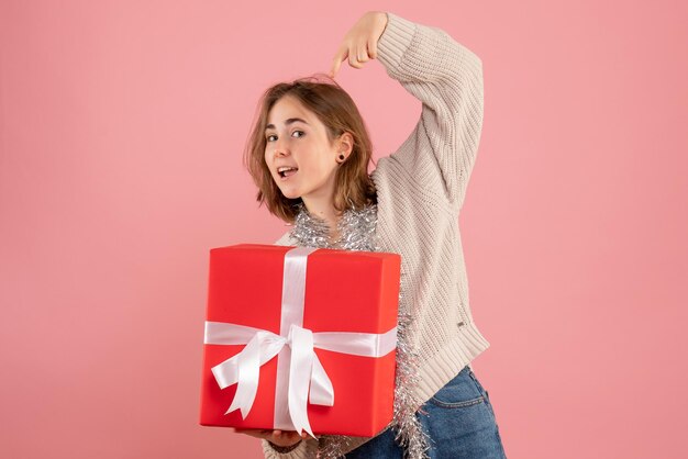 Front view young female holding xmas present