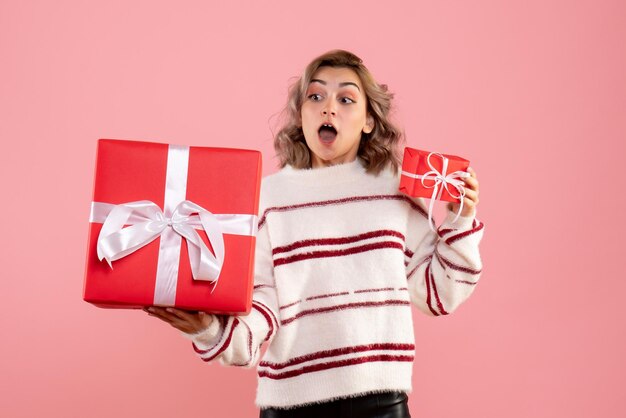 Front view young female holding xmas presents