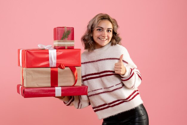 Front view young female holding xmas presents