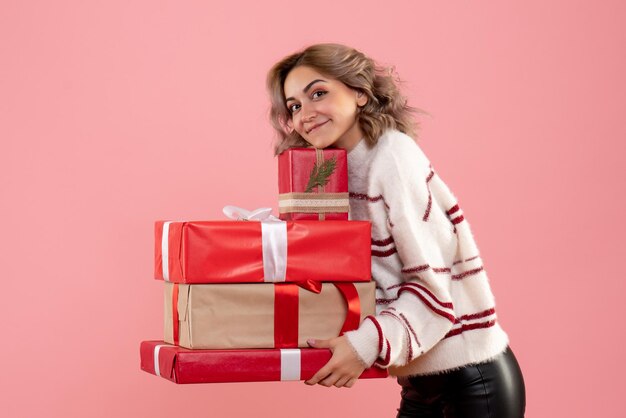 Front view young female holding xmas presents