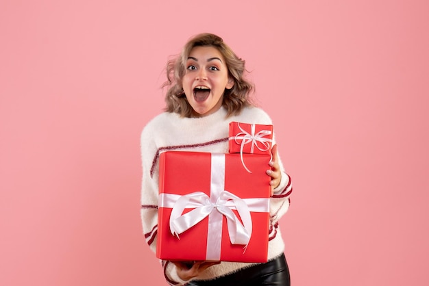 Front view young female holding xmas presents