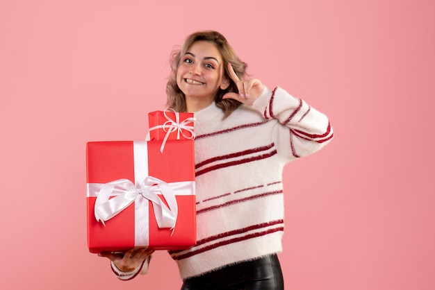 Front view young female holding xmas presents