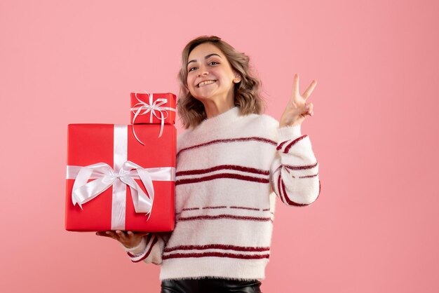 Front view young female holding xmas presents