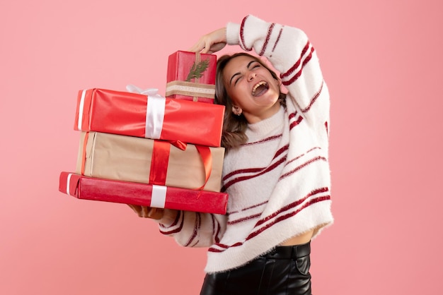 Front view young female holding xmas presents