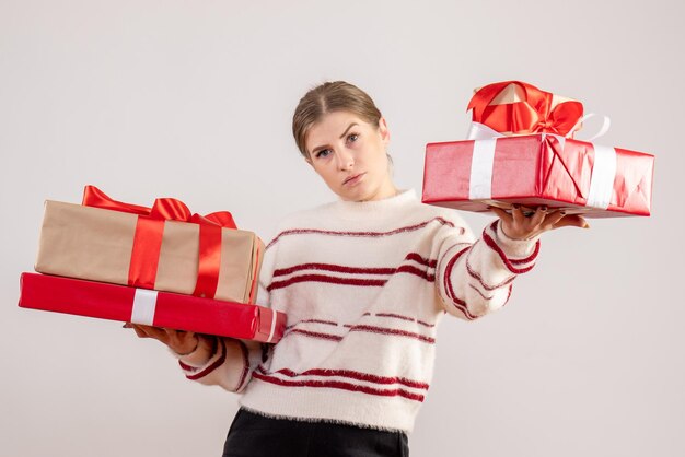 Front view young female holding xmas presents