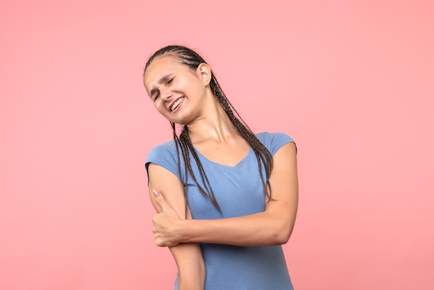 Free photo front view of young female hurt her arm on pink