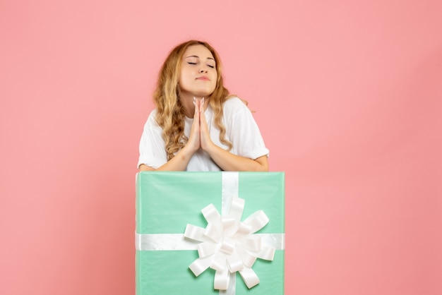 Front view young female inside blue present box