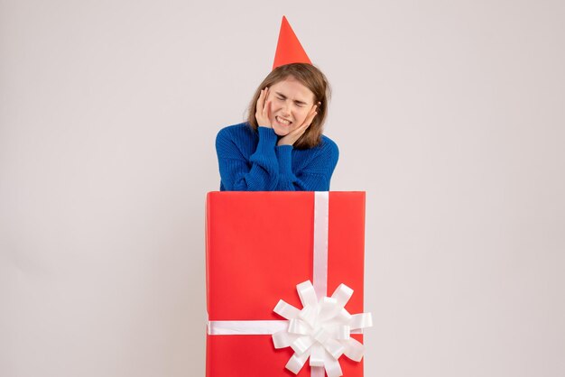 Front view young female inside red present box