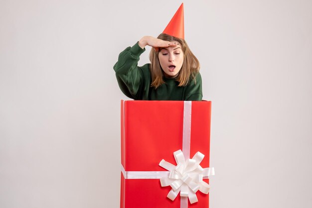 Front view young female inside red present box