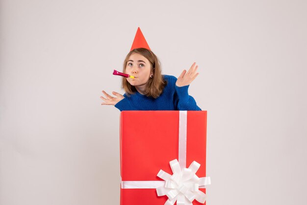 Front view young female inside red present box