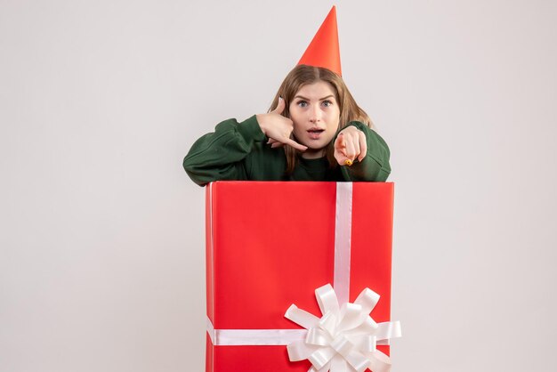 Front view young female inside red present box