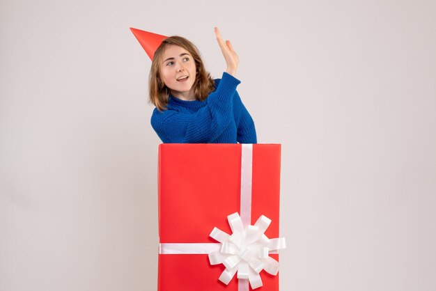 Front view young female inside red present box