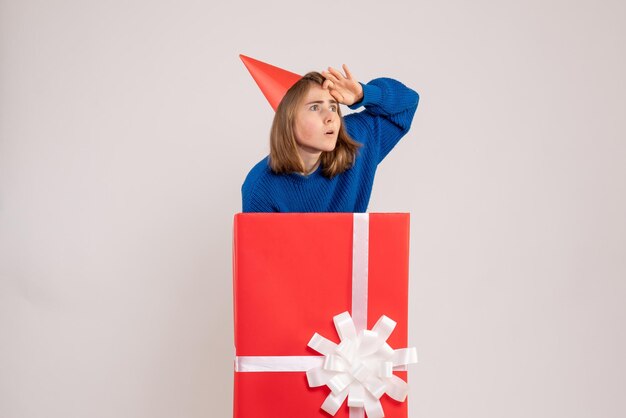 Front view young female inside red present box