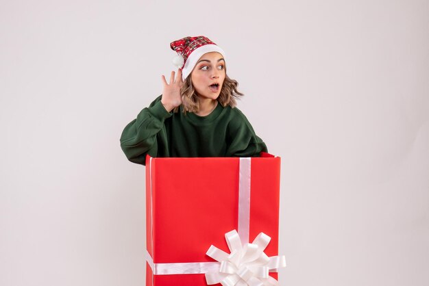 Front view young female inside red present box