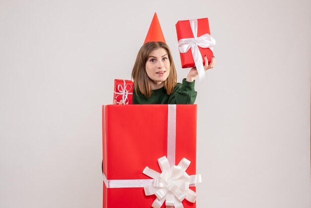 Front view young female inside red present box