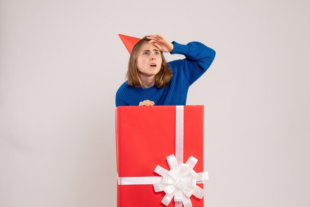 Front view young female inside red present box