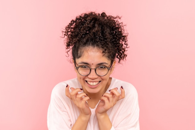 Free photo front view of young female laughing on pink