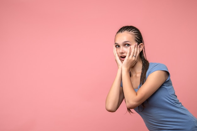 Front view of young female on pink girl youth model emotion color