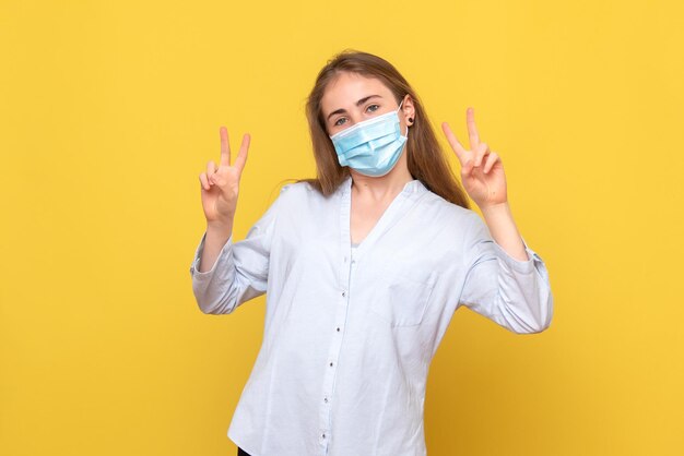 Front view of young female posing in mask