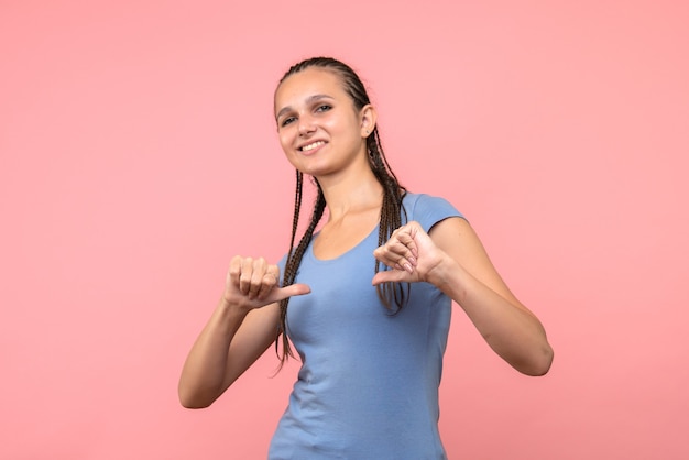 Free photo front view of young female posing on pink