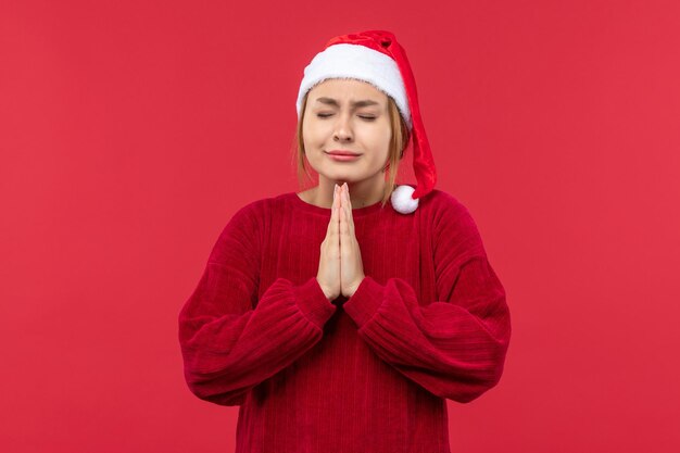 Front view young female praying, christmas holiday red