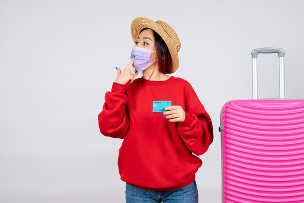 Free photo front view young female preparing for trip in mask on white wall