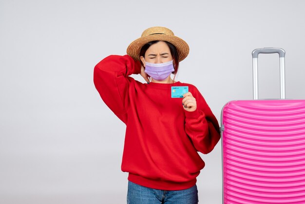 Front view young female preparing for trip in mask on white wall